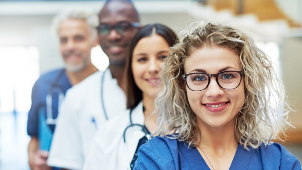 A smiling group of medical office employees.